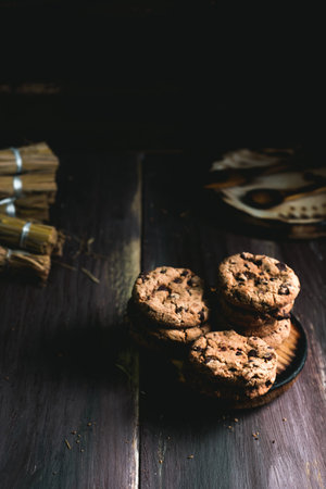 Chocolate cookies on wooden table. Chocolate chip cookies shot on blackの写真素材