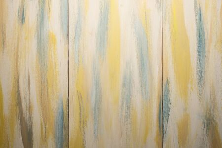 Texture. Background. Brown painted wooden board texture with yellow and green tones.の写真素材