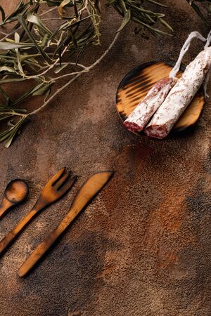 Cured Fuet chorizo, cheese, sausage from Spain. Salami sausage snack. Copy space. Wooden table background.の写真素材