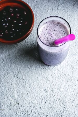 homemade blueberry smoothie on fresh white and blue wooden tableの写真素材