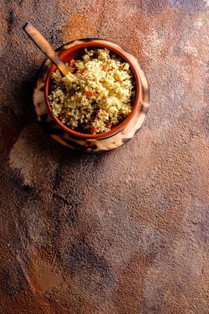 Tabule. Arabian vegetarian salad with couscous. Wooden background. Isolatedの写真素材