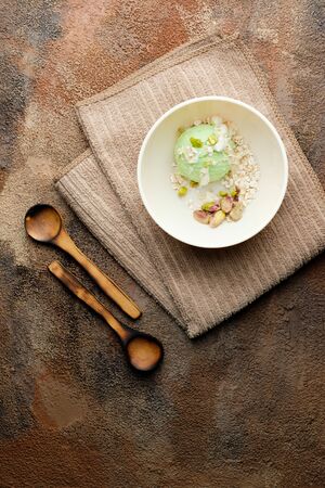 Pistachio ice cream with white chocolate on old wooden table. Healthy food. Vegan foodの写真素材