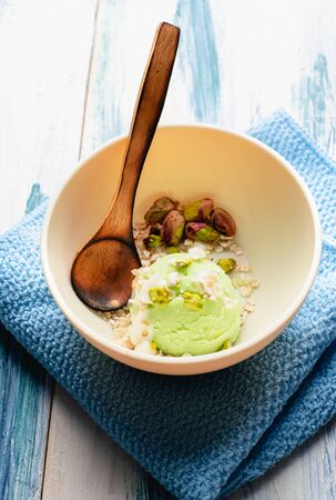 Pistachio ice cream with white chocolate on modern table. Healthy food. Vegan foodの写真素材