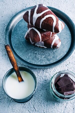 Delicious homemade dessert of black and white chocolate filled with cream. Triangle shaped dessert on wooden tableの写真素材