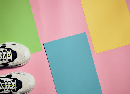 Black and white sports sneakers on colorful modern background with copy space