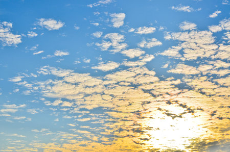 sun shining behind the clouds