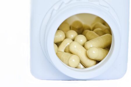 Herbs capsules in bottleの写真素材