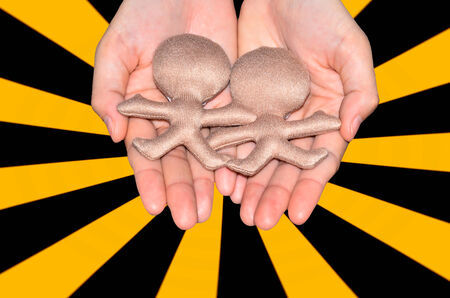 fabrics toy in hand on yellow black lightの写真素材