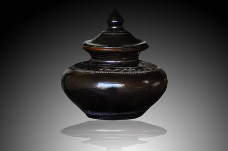 Black clay pot on white light backgroundの写真素材