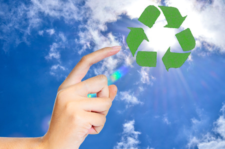 hand and recycle sign on nature background for green world conceptの写真素材
