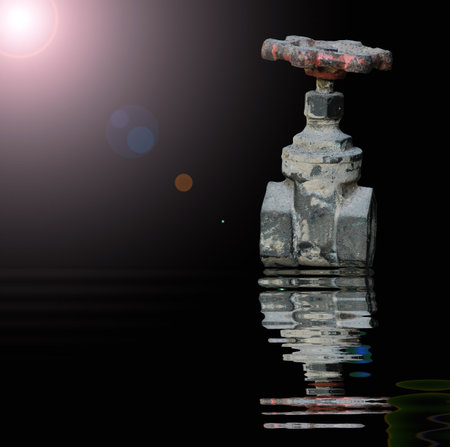 Old Water valve with reflected in waterの写真素材
