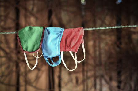 many mask hanging on the rope in vintage lightの写真素材