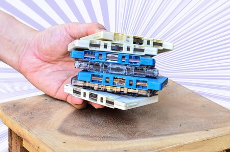 Tape Cassette analog audio in hand on the deskの写真素材