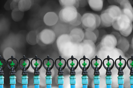 Many water sprinkler on black and white sunny abstractの写真素材