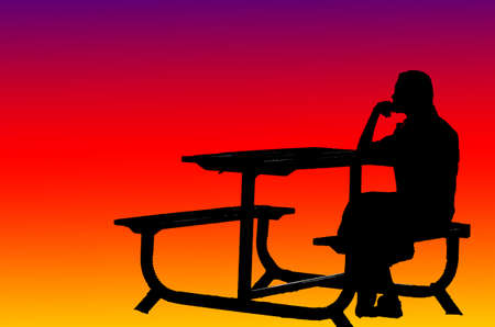 lonely girl sits on table in sunset backgroundの写真素材