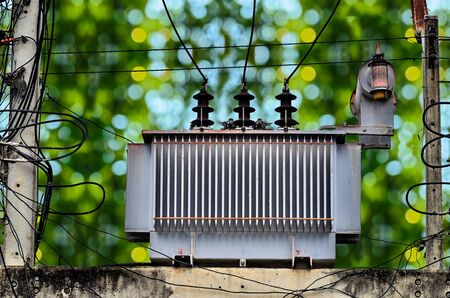 High voltage power transformer on green nature backgroundの写真素材