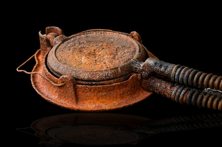 old waffle of pancake maker on black backgroundの写真素材