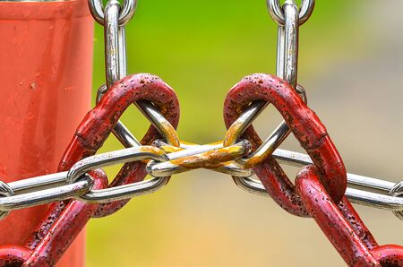 Red Chains Locked metal chains on nature backgroundの写真素材