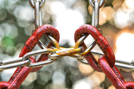 Red Chains Locked metal chains on nature bokea backgroundの写真素材
