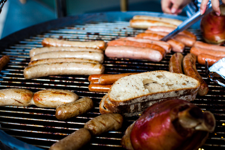 Several sausages grilled on the burnerの写真素材