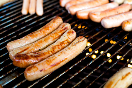 Several sausages grilled on the burnerの写真素材