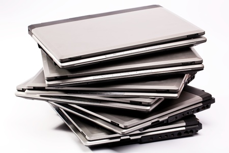 Pile of laptops on the white backgroundの写真素材
