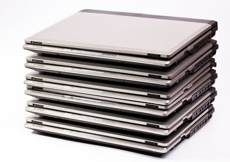 Pile of laptops on the white backgroundの写真素材