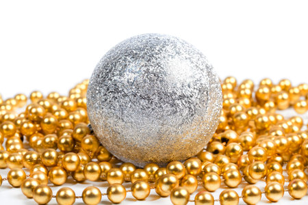 Silver ball with golden beads on white backgroundの写真素材