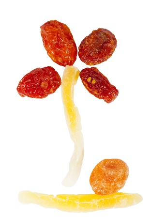 Flower shape made with dried sweet fruits on white backgroundの写真素材