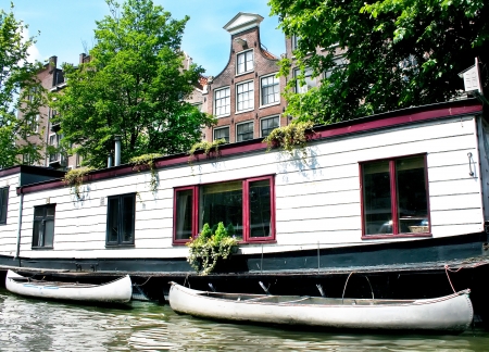 Floating house with boats in Amsterdamの写真素材