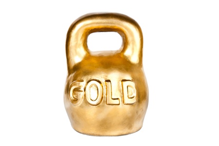 Golden kettebell isolated on whiteの写真素材