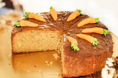 Carrot cake decorated with carrots on the topの写真素材