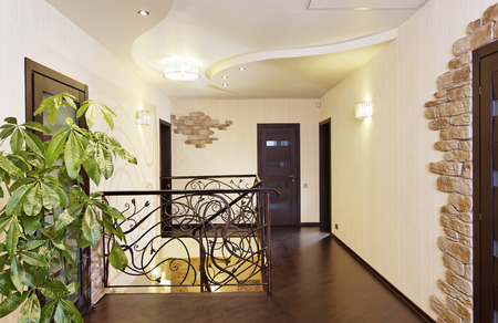 Classical stairs with ornamental handrail in hallway with doors の写真素材