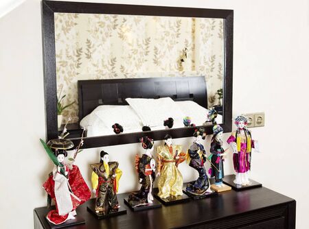 Japanese dolls near mirror in bedroom interiorの写真素材
