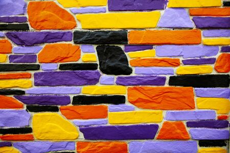 Multicolor violet and orange  brick wall close upの写真素材