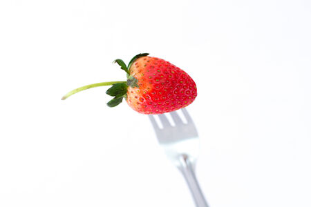 Fresh Stawberry and Fork on white  Background.の写真素材