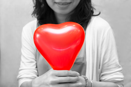 Red Balloon heart in woman hands