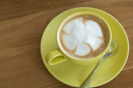 Hot coffee in the yellow Cup. lattte coffeeの写真素材