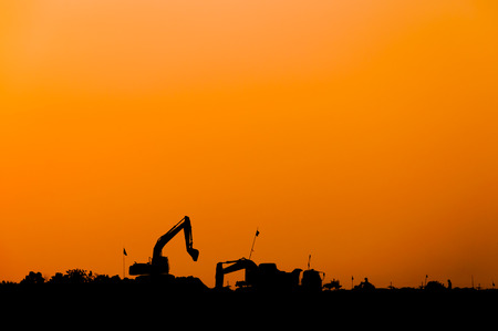 silhouette of excavator loader at construction site,Silhouette Backhoe,track-type loader excavator machine doing earthmovingの写真素材