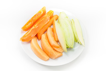fruit papaya mango and cantaloupe on dish on white backgroundの写真素材