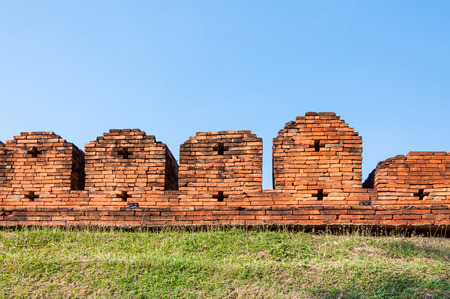 A portion of the ancient fortified city wall built of brick with cross bow cutouts and crenelations, Chiang Mai, Thailand ,Image of Fortressの写真素材