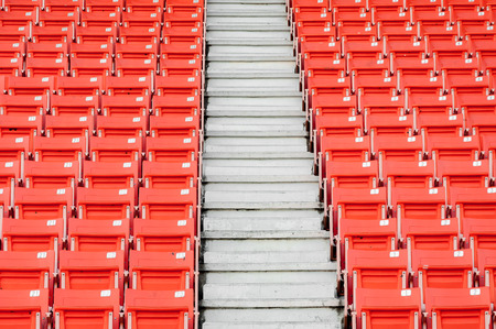 Empty orange seats at stadium,Rows of seat on a soccer stadiumの写真素材