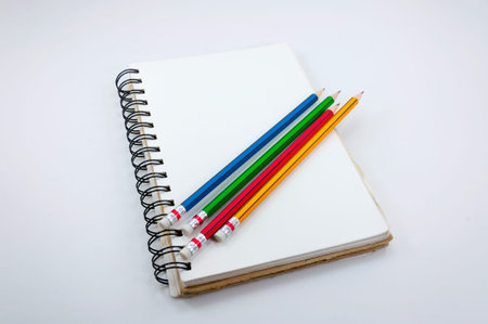 Notebook and Colorful Pencil  on white background
