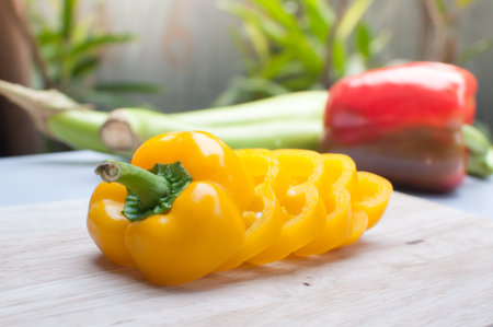 Fresh Yellow bell pepper sliced on wooden board