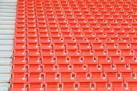 Empty orange seats at stadium,Rows of seat on a soccer stadiumのeditorial素材