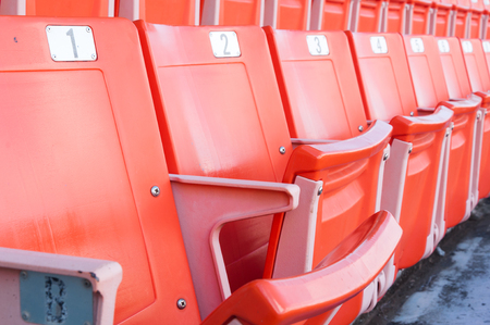 Empty orange seats at stadium,Rows of seat on a soccer stadiumのeditorial素材