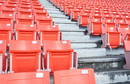 Empty orange seats at stadium,Rows of seat on a soccer stadiumのeditorial素材