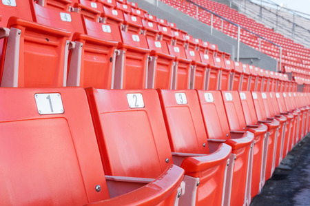 Empty orange seats at stadium,Rows of seat on a soccer stadiumの写真素材