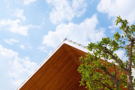 Wooden gabled roof with blue sky,triangles roof house sky backgroundの写真素材