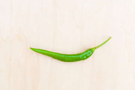 fresh green hot chilli peppers with spicy on the wooden